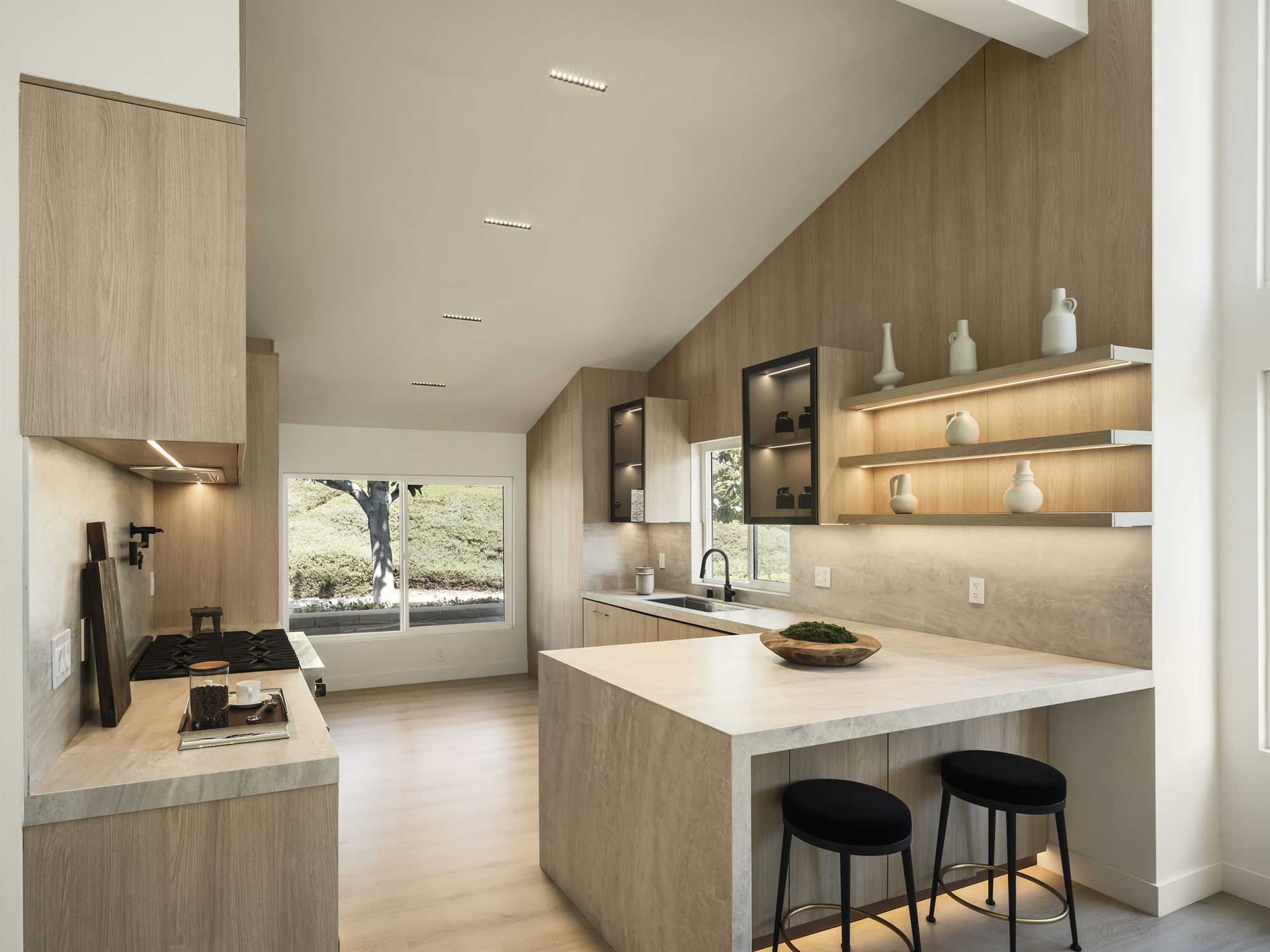 Chef-grade kitchen with marble waterfall island and walnut cabinetry